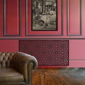 Islamic black geometric radiator covers on red wall